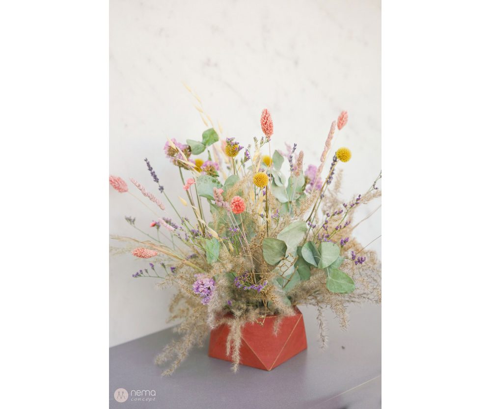 Dried flower arrangement in concrete vases